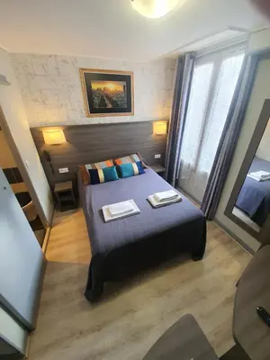 Un ou plusieurs lits dans un hébergement de l'établissement HOTEL SAVOY