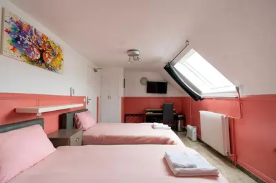 Un ou plusieurs lits dans un hébergement de l'établissement Hotel Geoffroy Marie Opéra