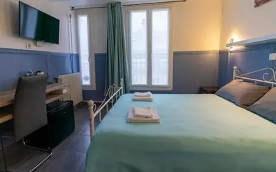 Un ou plusieurs lits dans un hébergement de l'établissement Hotel Geoffroy Marie Opéra