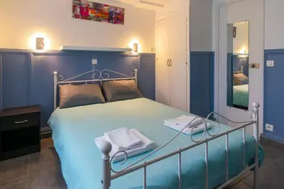 Un ou plusieurs lits dans un hébergement de l'établissement Hotel Geoffroy Marie Opéra