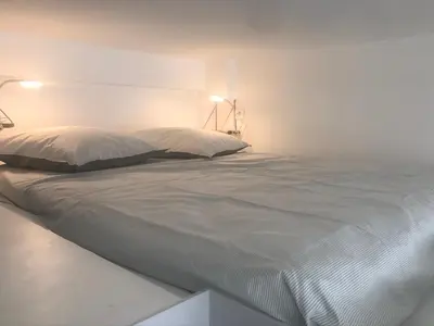 Un ou plusieurs lits dans un hébergement de l'établissement Magnifique Studio avec Mezzanine au Cœur de Paris