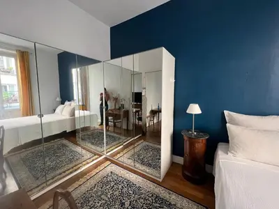 Un ou plusieurs lits dans un hébergement de l'établissement Maison de ville cosy Canal Saint Martin