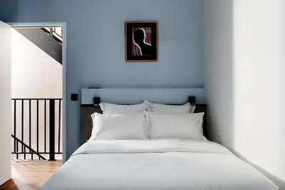 Un ou plusieurs lits dans un hébergement de l'établissement Edgar Suites Notre-Dame - Lagrange