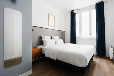 Un ou plusieurs lits dans un hébergement de l'établissement Edgar Suites Notre-Dame - Lagrange