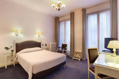 Un ou plusieurs lits dans un hébergement de l'établissement HOTEL DU PRINTEMPS