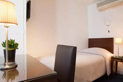 Un ou plusieurs lits dans un hébergement de l'établissement HOTEL DU PRINTEMPS