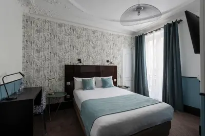 Un ou plusieurs lits dans un hébergement de l'établissement Lennon by Avalon Hotel Paris Gare du Nord