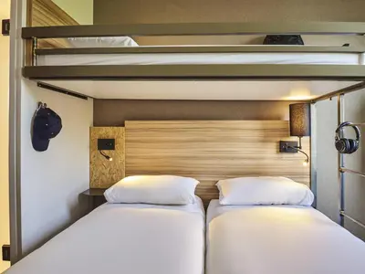 Un ou plusieurs lits dans un hébergement de l'établissement Ibis Budget Paris porte de la Chapelle - Aréna