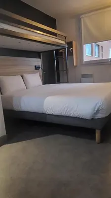 Un ou plusieurs lits dans un hébergement de l'établissement Ibis Budget Paris porte de la Chapelle - Aréna