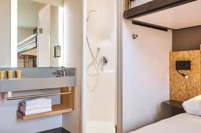 Un ou plusieurs lits dans un hébergement de l'établissement Ibis Budget Paris porte de la Chapelle - Aréna