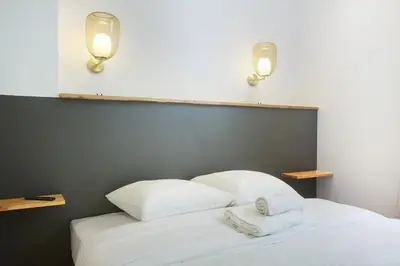 Un ou plusieurs lits dans un hébergement de l'établissement Apartment Palais Royal by Studio prestige