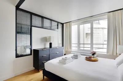 Un ou plusieurs lits dans un hébergement de l'établissement Amazing apartments - Arc de Triomphe-Champs Elysée