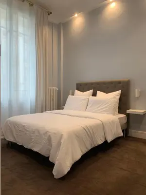 Un ou plusieurs lits dans un hébergement de l'établissement Charming Eiffel Tower Appartement