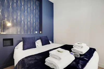 Un ou plusieurs lits dans un hébergement de l'établissement Modern Apartment 1BR- 4P Le Marais Quarter