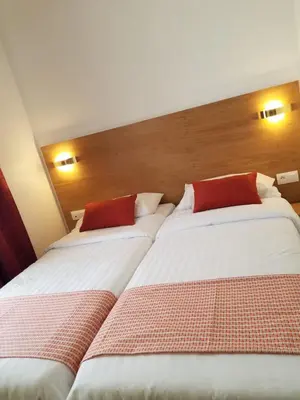 Un ou plusieurs lits dans un hébergement de l'établissement Dupleix Hotel