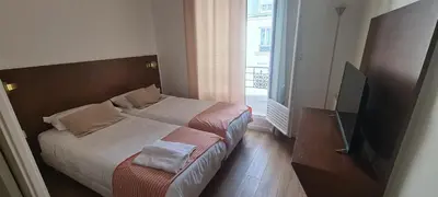 Un ou plusieurs lits dans un hébergement de l'établissement Dupleix Hotel