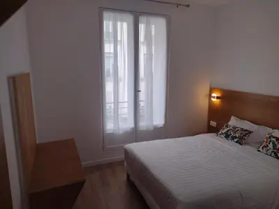 Un ou plusieurs lits dans un hébergement de l'établissement Dupleix Hotel