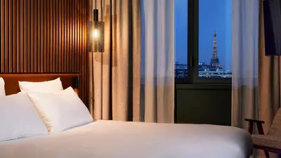 Un ou plusieurs lits dans un hébergement de l'établissement Le Bellune Paris