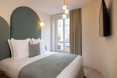 Un ou plusieurs lits dans un hébergement de l'établissement Yuna Saint-Honoré - Serviced Apartments