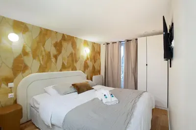 Un ou plusieurs lits dans un hébergement de l'établissement Apartment center of Paris by Studio prestige