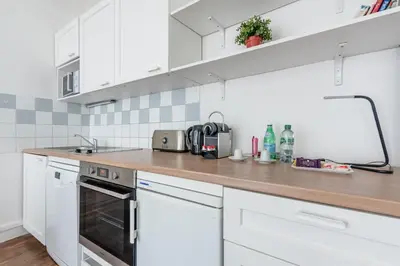 Cuisine ou kitchenette dans l'établissement Appartement Magenta Quest