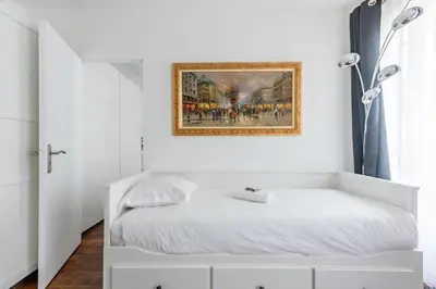 Un ou plusieurs lits dans un hébergement de l'établissement Appartement Magenta Quest