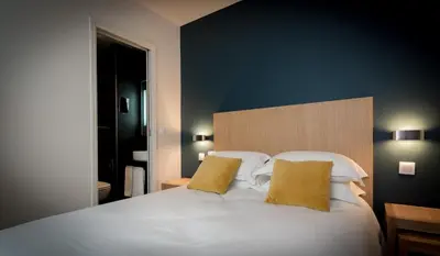 Un ou plusieurs lits dans un hébergement de l'établissement Hotel Mirabeau Eiffel