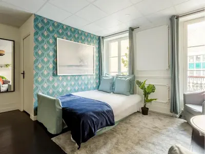 Un ou plusieurs lits dans un hébergement de l'établissement Merveil - Family Suite - Champs Elysees - Armee