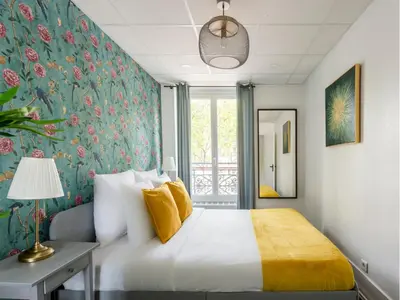 Un ou plusieurs lits dans un hébergement de l'établissement Merveil - Family Suite - Champs Elysees - Armee
