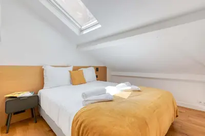 Un ou plusieurs lits dans un hébergement de l'établissement Les Cottages de Montmartre - Secret Courtyard