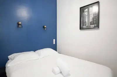 Un ou plusieurs lits dans un hébergement de l'établissement Superbe studio proche tour Eiffel