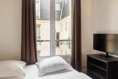 Un ou plusieurs lits dans un hébergement de l'établissement Pied-a-terre near Bastille & Voltaire Paris 11th