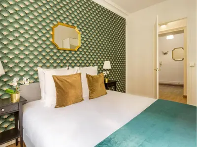 Un ou plusieurs lits dans un hébergement de l'établissement Merveil - Family Suite - Champs Elysees - Mollien