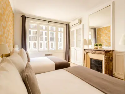 Un ou plusieurs lits dans un hébergement de l'établissement Merveil - Family Suite - Champs Elysees - Mollien