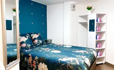 Un ou plusieurs lits dans un hébergement de l'établissement Jolie appartement avec 2 chambres partagées