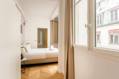 Un ou plusieurs lits dans un hébergement de l'établissement Reva Suites