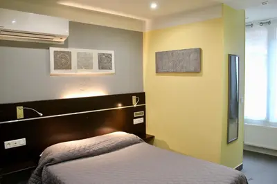 Un ou plusieurs lits dans un hébergement de l'établissement Hotel des Pyrénées