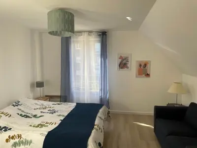 Un ou plusieurs lits dans un hébergement de l'établissement Maison agréable et spacieuse aux portes de Paris et du métro