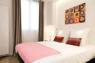 Un ou plusieurs lits dans un hébergement de l'établissement Arc de Triomphe Apartment