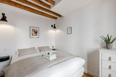 Un ou plusieurs lits dans un hébergement de l'établissement Appartement Grenelle - Welkeys