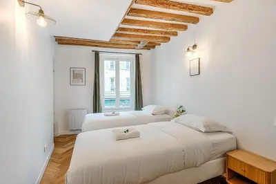 Un ou plusieurs lits dans un hébergement de l'établissement Appartement Grenelle - Welkeys