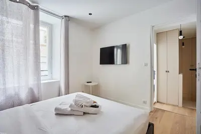 Un ou plusieurs lits dans un hébergement de l'établissement Apartment Louvre Museum by Studio prestige