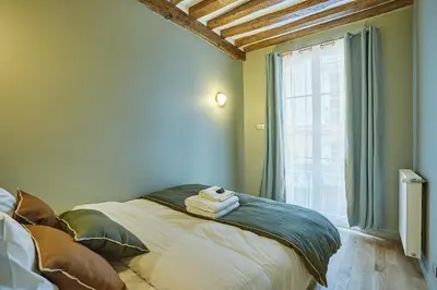 Un ou plusieurs lits dans un hébergement de l'établissement Residence Center of Paris by Studio prestige