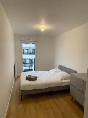 Un ou plusieurs lits dans un hébergement de l'établissement Appartement Saint ouen proche stade de france