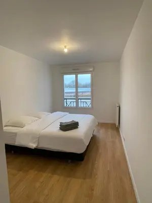 Un ou plusieurs lits dans un hébergement de l'établissement Appartement Saint ouen proche stade de france