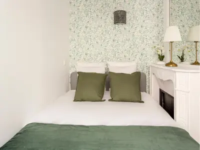 Un ou plusieurs lits dans un hébergement de l'établissement Merveil - Family Suite - Champs Elysees - Wagram