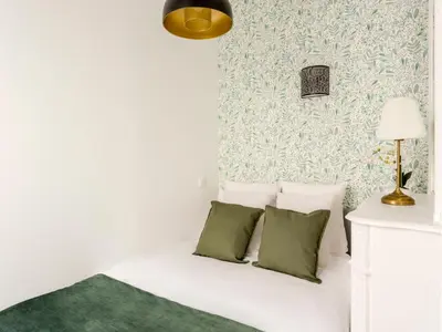 Un ou plusieurs lits dans un hébergement de l'établissement Merveil - Family Suite - Champs Elysees - Wagram