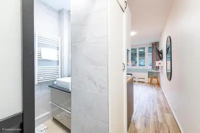Un ou plusieurs lits dans un hébergement de l'établissement Studio Moderne au coeur de Paris