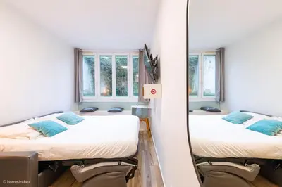 Un ou plusieurs lits dans un hébergement de l'établissement Studio Moderne au coeur de Paris