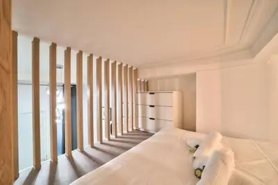 Un ou plusieurs lits dans un hébergement de l'établissement Bel appartement au coeur de Montmartre